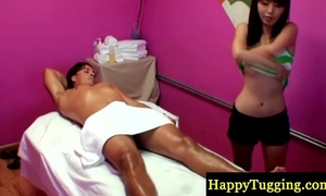 Asian masseur tugs her clients rod
