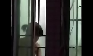 Nude neighbor captured in the kitchen
