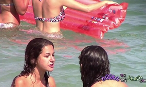 Two italian cuties playing underneath the water on the topless beach