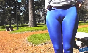 Round arse legal age teenager in ultra constricted shiny spandex showing cameltoe in public!
